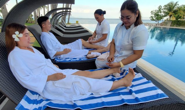 two-guests-having-their-manicure-and-pedicure-beside-our-infinity-pol